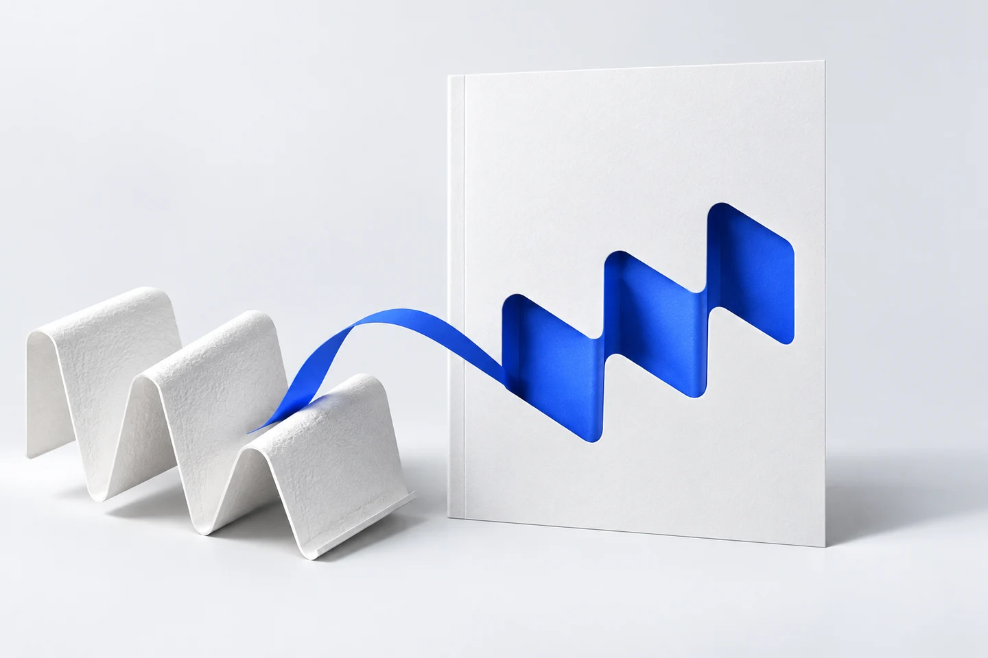 A folded material sample becomes the matching blue cutout motif on a paper cover, illustrating a cover concept derived from a company's own material.
